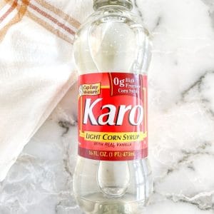 A bottle of Karo syrup on a table.
