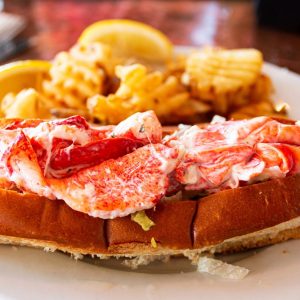 Lobster sandwich with waffle fries.