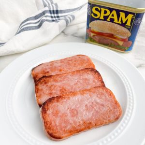 Sliced, cooked SPAM on a plate.