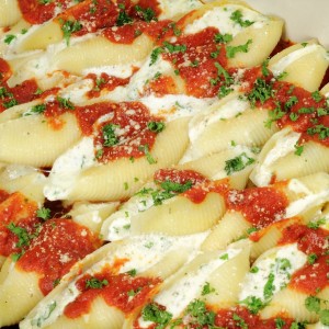 Stuffed shells topped with red sauce.