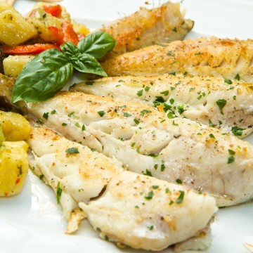 Cooked fish fillets with potatoes.